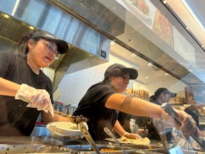 Workers fill food orders at a Chipotle restaurant on April 01, 2024 in San Rafael, Calif.