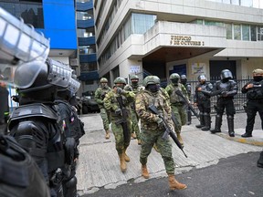 - Military and police officers deploy a security operation during the exit of former Ecuadorian vice president Jorge Glas from the Flagrancy Unit of the Public Prosecutor's Office in Quito on April 6, 2024.
