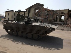 Ukrainian servicemen drive an infantry fighting vehicle (IVF) past the destroyed railway station in the town of Kostyantynivka, Donetsk region, on April 11, 2024, amid the Russian invassion in Ukraine.