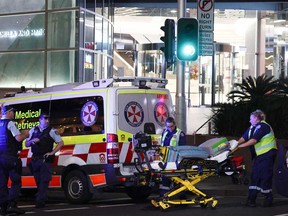 Paramedics move a stretcher with medical equipment outside the Westfield Bondi Junction shopping mall after a stabbing incident in Sydney on April 13, 2024.