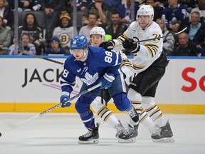 William Nylander of the Toronto Maple Leafs skates against Jake DeBrusk of the Boston Bruins.