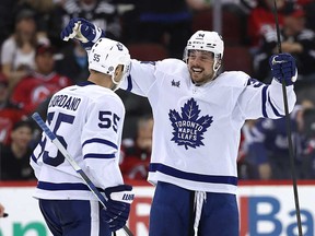 Mark Giordano #55 of the Toronto Maple Leafs is congratulated by teammate Auston Matthews #34 after Giordano scored during the second period against the New Jersey Devils react at Prudential Center on April 9, 2024 in Newark, N.J.