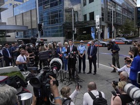 Chris Minns, premier of New South Wales state, center, speaks to media at Bondi Junction in Sydney, Sunday, April 14, 2024, after several people were stabbed to death at a shopping center Saturday.