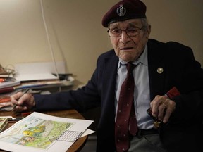 D-Day veteran Bill Gladden shows off one of his paintings, that depicts the type of glider in which he landed in Normandy on D-Day, at his home in Haverhill, England, Friday, Jan. 12, 2024.