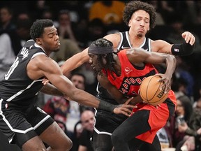 Brooklyn Nets centre Day'Ron Sharpe and forward Jalen Wilson guard Toronto Raptors forward Mouhamadou Gueye.