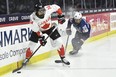 Canada defender Renata Fast (left) looks to pass while pressured by Team U.S.A.'s Alex Carpenter during the first period in the final at the IIHF women's world hockey championship in Utica, N.Y., Sunday, April 14, 2024.