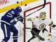 Maple Leafs' John Tavares is hit by the puck as Boston Bruins goaltender Jeremy Swayman looks on during the first period in Game 3 of their first-round playoff series in Toronto on Wednesday, April 24, 2024.