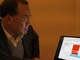 Zhang Yongzhen, the first scientist to publish a sequence of the COVID-19 virus, looks at a presentation on his laptop in a coffeeshop in Shanghai, China on Dec. 13, 2020.
