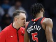 Toronto Raptors head coach Darko Rajakovic, left, talks to guard Immanuel Quickley.