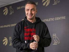 Toronto Raptors head coach Darko Rajakovic stands and smiles
