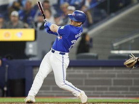 Blue Jays batter Daulton Varsho hits a grand slam in the first inning against the Rockies at Rogers Centre in Toronto, Saturday, April 13, 2024.