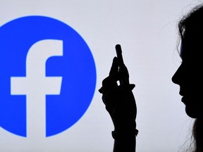 Silhouette of hands and face with Facebook logo