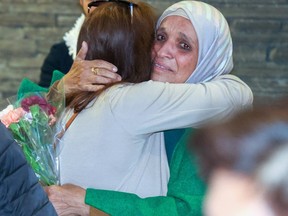 A Gazan refugee hugs a family member.