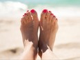 Woman's pretty feet in the sand.