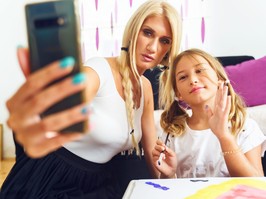 Mother and daughter taking selfie.