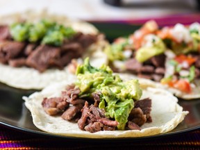 Grilled beef served on soft corn tortillas with guacamole, salsa verde and pico de gallo.