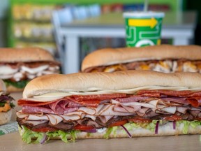 Subway sandwiches on display in Subway restaurant.