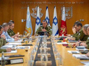 This handout picture released by the Israeli Army shows the head of the military, Lieutenant General Herzi Halevi (centre), attending a situational assessment with members of the General Staff Forum at the Kirya military base, which houses the Defence Ministry in Tel Aviv, on April 14, 2024.