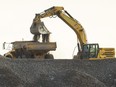 A dump truck is loaded with fill as work continues to ready the site of Volkswagen's PowerCo electric-vehicle battery plant in St. Thomas. Photograph taken on Thursday, Dec. 21, 2023. (Mike Hensen/The London Free Press)