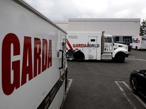 Armoured trucks are parked outside the offices of GardaWorld in the Sylmar section of Los Angeles on Thursday, April 4, 2024.