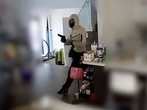Security footage of a home invasion. A person holding a gun