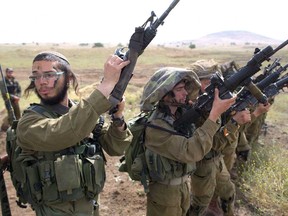 Israeli soldiers of the Ultra-Orthodox battalion "Netzah Yehuda" take part in their annual unit training in the Israeli annexed Golan Heights, near the Syrian border on May 19, 2014.