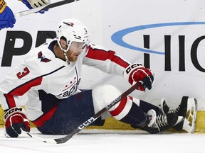 In this file photo taken on April 11, 2024, Washington Capitals defenceman Nick Jensen is knocked to the ice by Buffalo Sabres left wing Zemgus Girgensons during the first period of an NHL hockey game in Buffalo, N.Y.