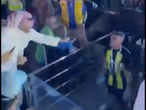 A soccer fan hits Abderrazak Hamdallah with a whip.