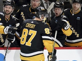 Penguins captain Sidney Crosby (87) returns to the bench after scoring against the Red Wings during the second period of an NHL game in Pittsburgh, Thursday, April 11, 2024.