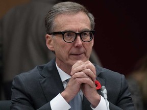 Bank of Canada Governor Tiff Macklem reads his notes as he waits to appear at the Senate Committee on Banking, Commerce and the Economy, in Ottawa, Wednesday, Nov. 1, 2023.