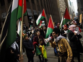 Protesters for Gaza gather outside the King Edward Hotel, in Toronto, the planned location of an event for Prime Minister Justin Trudeau, Mar. 15, 2024.