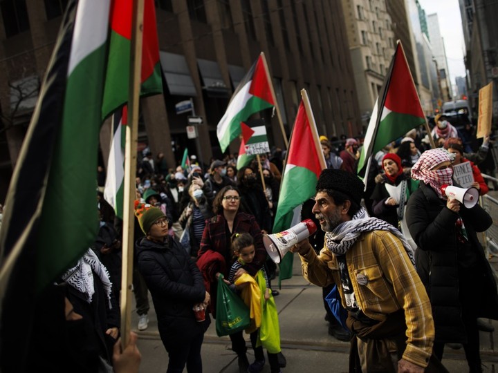  Protesters for Gaza gather outside the King Edward Hotel, in Toronto, the planned location of an event for Prime Minister Justin Trudeau, Mar. 15, 2024. (Cole Burston/The Canadian Press)