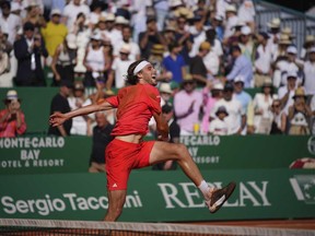 Stefanos Tsitsipas of Greece celebrates after winning the second set against Casper Ruud of Norway to win the Monte Carlo Tennis Masters final match 6-1, 6-4 in Monaco, Sunday, April 14, 2024.