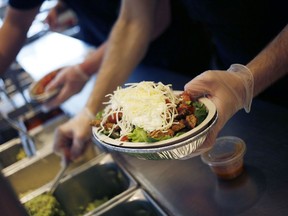 An employee prepares a burrito bowl at a Chipotle Mexican Grill Inc. restaurant in Louisville, Kentucky.