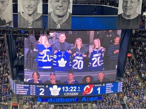 The family of Rodion Amirov looks on during an in-game tribute during Thursday night's Maple Leafs-Devils game in Toronto.