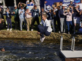 Nelly Korda jumps into the lake after winning the Chevron Championship LPGA golf tournament Sunday, April 21, 2024, at The Club at Carlton Woods in The Woodlands, Texas.