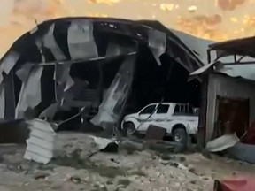 This image grab from a UGC video posted on April 20, 2024, shows damage following an alleged bombing overnight on an Iraqi military base in the central province of Babylon housing a coalition of pro-Iranian armed groups.