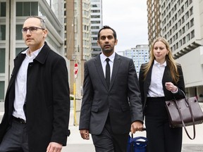 Umar Zameer and his lawyers walk away from the courthouse following his not guilty verdict, in Toronto, Sunday, April 21, 2024.