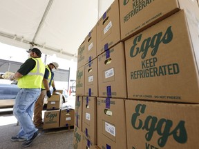 Cases of eggs from Cal-Maine Foods, Inc., wait to be handed out by the Mississippi Department of Agriculture and Commerce employees at the Mississippi State Fairgrounds in Jackson, Miss., on Aug. 7, 2020.