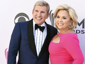 Todd Chrisley, left, and his wife, Julie Chrisley, pose for photos at the 52nd annual Academy of Country Music Awards on April 2, 2017, in Las Vegas.