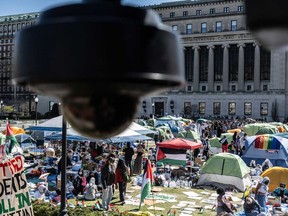 Columbia University students participate in an ongoing pro-Palestinian encampment on their campus following last week's arrest of more than 100 protesters on April 23, 2024 in New York City.