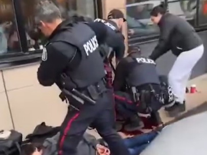 Video of the blood-soaked scene was posted on social media after a Toronto cop was stabbed and the suspect was shot by police out front of a Tim Hortons near College St. and Lansdowne Ave. on Friday, April 12, 2024.