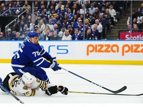 Toronto Maple Leafs' Ryan Reaves (75) is checked by Boston Bruins' Brandon Carlo (25) during second period action in Game 3 of an NHL hockey Stanley Cup first-round playoff series in Toronto on Wednesday, April 24, 2024.