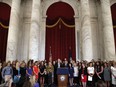 FILE - Sen. Jerry Moran, R-Kansas, center left, and Sen. Richard Blumenthal, D-Conn., attend a news conference with dozens of women and girls who were sexually abused by Larry Nassar, a former doctor for Michigan State University athletics and USA Gymnastics, July 24, 2018, on Capitol Hill in Washington. The U.S. Justice Department has agreed to pay approximately $100 million to settle claims with about 100 sexual assault victims of Nassar, a source with direct knowledge of the negotiations told The Associated Press on Wednesday, April 17, 2024.