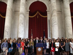 FILE - Sen. Jerry Moran, R-Kansas, center left, and Sen. Richard Blumenthal, D-Conn., attend a news conference with dozens of women and girls who were sexually abused by Larry Nassar, a former doctor for Michigan State University athletics and USA Gymnastics, July 24, 2018, on Capitol Hill in Washington. The U.S. Justice Department has agreed to pay approximately $100 million to settle claims with about 100 sexual assault victims of Nassar, a source with direct knowledge of the negotiations told The Associated Press on Wednesday, April 17, 2024.