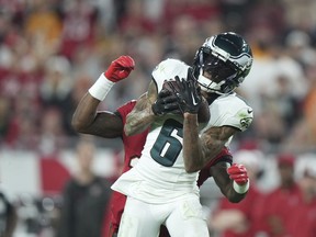 FILE - Philadelphia Eagles wide receiver DeVonta Smith (6) catches a deep pass as Tampa Bay Buccaneers cornerback Jamel Dean (35) defends during an NFL wild-card playoff football game, Monday, Jan. 15, 2024, in Tampa, Fla. The Philadelphia Eagles agreed to terms with wide receiver DeVonta Smith on a three-year contract extension through the 2028 season on Monday, April 15, 2024.