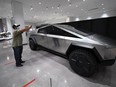 Visitors view the Tesla Cybertruck at the Petersen Automotive Museum in Los Angeles July 1, 2020.