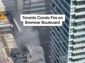 Smoke is seen billowing from a residential building near the York St.-Bremner Blvd. area and Maple Leaf Square.