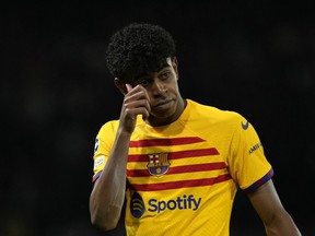 Barcelona's Lamine Yamal gestures during the Champions League quarterfinal first leg soccer match between Paris Saint-Germain and Barcelona at the Parc des Princes stadium in Paris, Wednesday, April 10, 2024.