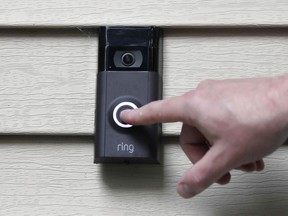 FILE - A person pushes the doorbell on his Ring doorbell camera, July 16, 2019, at his home in Wolcott, Conn. The Federal Trade Commission is sending $5.6 million in refunds to consumers as part of a settlement with Amazon-owned Ring, which was charged with failing to protect private video footage from outside access.